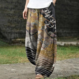 Coralie – Weite goldene Hose mit Kranich- und Wolkenmuster