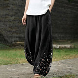 Armelle – Weite schwarze Hose mit floralem Muster